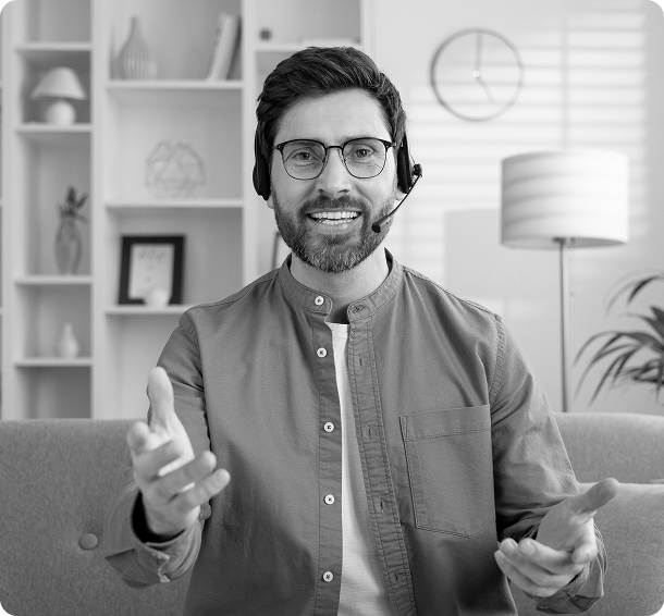 Man with headset smiling and gesturing
